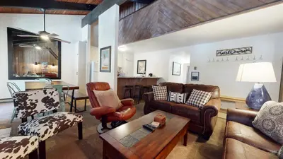 a living room with leather furniture and a table at Horizons 4 #150 Condo in Mammoth Lakes