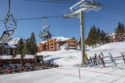 a ski resort with a ski lift and people on the snow at Sunstone #114 Condo in Mammoth Lakes