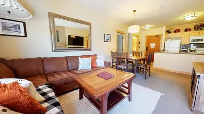 a living room with a brown couch and a table at Sunstone #114 Condo in Mammoth Lakes