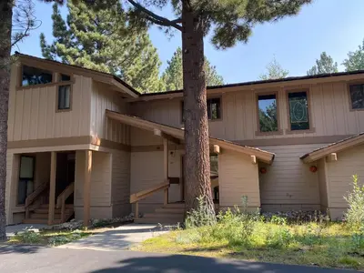 a house with a tree in front of it at Condo de los Pinos #30 in Mammoth Lakes