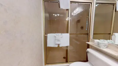 a bathroom with a shower and a toilet and towels at Condo de los Pinos #30 in Mammoth Lakes