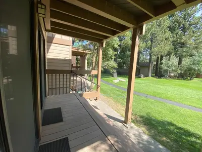 a screened porch with a view of a yard at Condo de los Pinos #30 in Mammoth Lakes