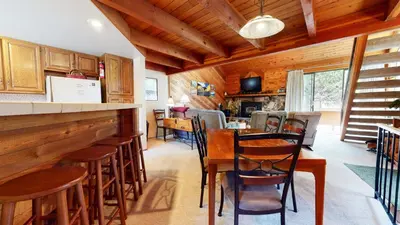 a kitchen and dining room with a table and chairs at Snowflower #81 Condo in Mammoth Lakes