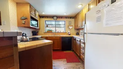 a kitchen with a refrigerator and a sink at Snowflower #81 Condo in Mammoth Lakes