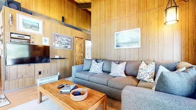 a living room with a couch and a tv at Chateau Blanc #25 Condo in Mammoth Lakes