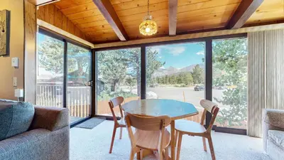 a living room with a table and chairs and a couch at Chateau Blanc #25 Condo in Mammoth Lakes