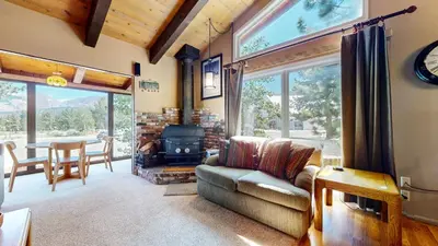 a living room with a couch and a stove at Chateau Blanc #25 Condo in Mammoth Lakes