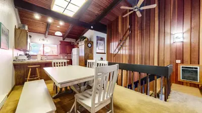 a kitchen and dining room with a table and chairs at Mammoth West #111 Condo in Mammoth Lakes