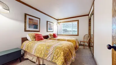 a bedroom with two beds and a window at Mammoth West #111 Condo in Mammoth Lakes