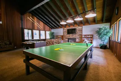 a ping pong table in a living room with at Mammoth West #111 Condo in Mammoth Lakes