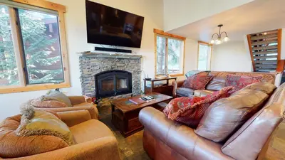 a living room with leather couches and a fireplace at Bridges Townhome #15 Condo in Mammoth Lakes