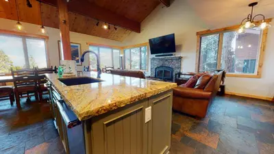 a kitchen with a counter top and a living room at Bridges Townhome #15 Condo in Mammoth Lakes