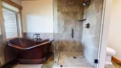 a bathroom with a copper tub and a shower at Bridges Townhome #15 Condo in Mammoth Lakes