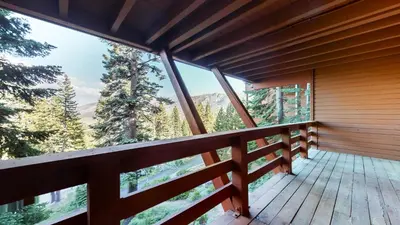 a balcony of a cabin with a view of the mountains at Bridges Townhome #15 Condo in Mammoth Lakes