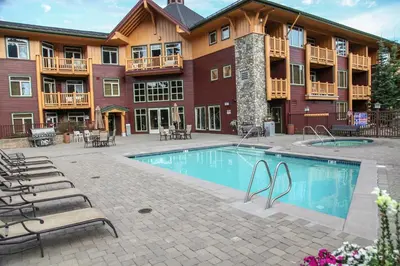 a hotel with a swimming pool in front of a building at Sunstone #103 Condo in Mammoth Lakes