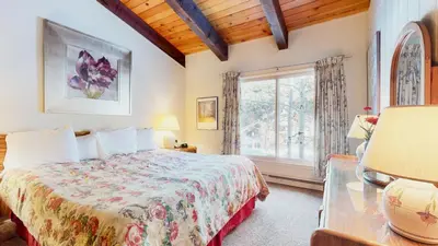 a bedroom with a bed and a large window at Chateau De Montagne #3 Condo in Mammoth Lakes