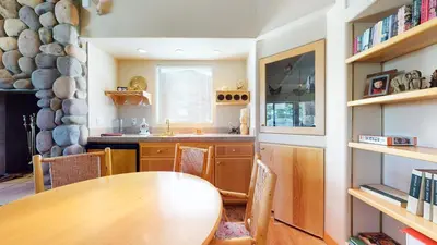 a kitchen with a wooden table and a dining room at Mammoth West #137 Condo in Mammoth Lakes