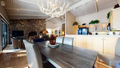 a dining room with a long wooden table and chairs at Mammoth West #137 Condo in Mammoth Lakes