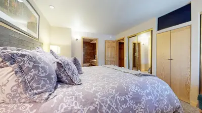 a bedroom with a bed with pillows on it at Mammoth West #137 Condo in Mammoth Lakes