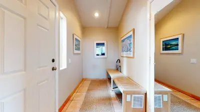 a hallway with a wooden bench in a house at Mammoth West #137 Condo in Mammoth Lakes