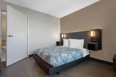 a hotel room with a bed and a door at Motel 6-Merced, CA - North in Merced