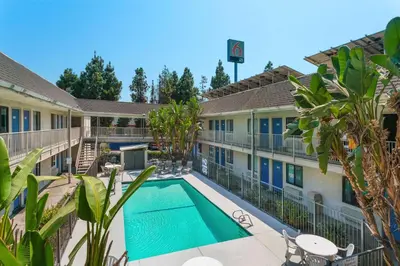 a view of the courtyard of a hotel with a swimming pool at Motel 6-Merced, CA - North in Merced