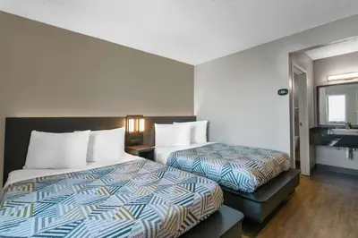 a hotel room with two beds and a sink at Motel 6-Merced, CA - North in Merced