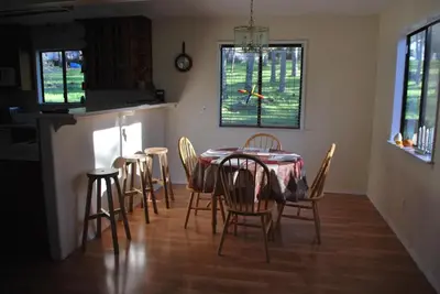 a dining room with a table and chairs in a kitchen at Yosemite is Calling in Groveland