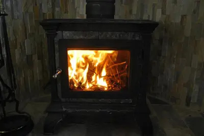 a fireplace with a fire in it at Yosemite is Calling in Groveland