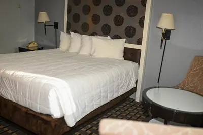 a hotel room with a bed and a chair at Budget INN At The Heavenly Gondola in South Lake Tahoe