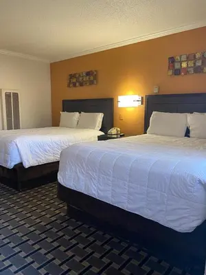 a hotel room with two beds and a lamp at Budget INN At The Heavenly Gondola in South Lake Tahoe