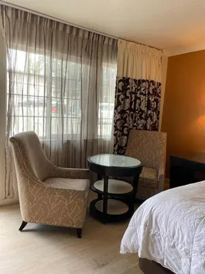 a bedroom with a bed and a table and chairs at Budget INN At The Heavenly Gondola in South Lake Tahoe