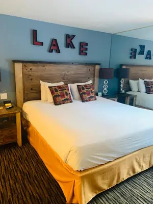a large white bed in a room with a blue wall at Postmarc Hotel and Spa Suites in South Lake Tahoe