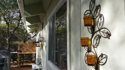 a building with two flower pots on the wall at Lovely Mountain Lake Chalet by Yosemite: Equipped! in Groveland