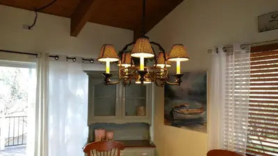 a chandelier is hanging in a kitchen with a window at Lovely Mountain Lake Chalet by Yosemite: Equipped! in Groveland