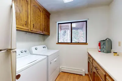 a kitchen with a washer and dryer and a window at House on Cold Creek in South Lake Tahoe