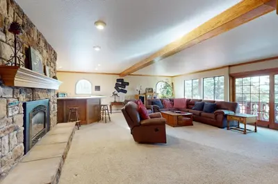 a living room with a couch and a fireplace at House on Cold Creek in South Lake Tahoe