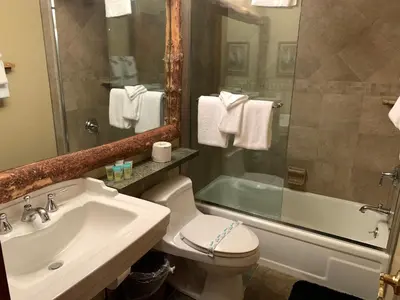 a bathroom with a sink and a toilet and a tub at Mountainback 79 Loft Den in Mammoth Lakes