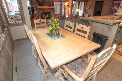 a wooden table and chairs in a kitchen at Mountainback 48 Corner Unit in Mammoth Lakes