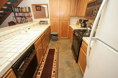 a small kitchen with a sink and a stove at Mountainback 41 Loft in Mammoth Lakes
