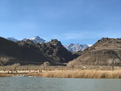 a view of a river with mountains in the background at Mountainback 40 Loft Corner in Mammoth Lakes