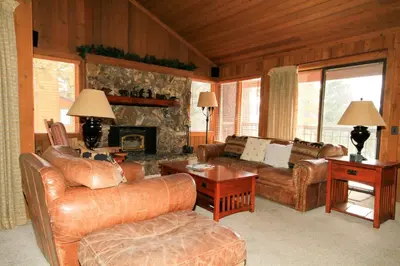 a living room with leather furniture and a fireplace at Mountainback 40 Loft Corner in Mammoth Lakes