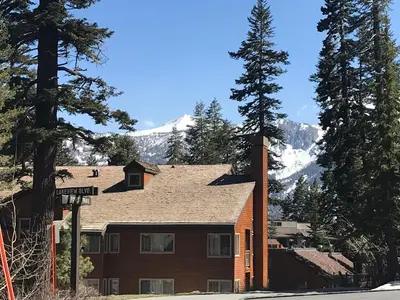 a house with a mountain in the background at Mountainback 40 Loft Corner in Mammoth Lakes