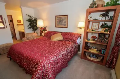 a bedroom with a bed with a red bedspread at Mountainback 38 pet unit in Mammoth Lakes
