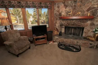 a living room with a chair and a fireplace at Mountainback 38 pet unit in Mammoth Lakes