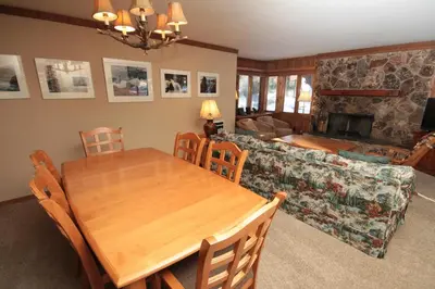 a dining room and living room with a table and a couch at Mountainback 37 Den in Mammoth Lakes