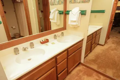 a bathroom with two sinks and a mirror at Mountainback 34 Corner in Mammoth Lakes