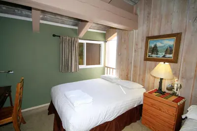 a bedroom with a large bed and a window at Mammoth Ski Racquet Club 64 - Pet Friendly in Mammoth Lakes