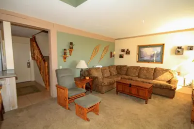 a living room with a couch and a chair at Mammoth Ski Racquet Club 64 - Pet Friendly in Mammoth Lakes