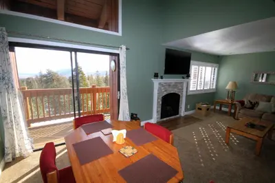 a dining room with a table and a fireplace at Mammoth Ski Racquet Club 66 in Mammoth Lakes